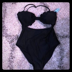 Black one piece with middle cut out. Never worn!!